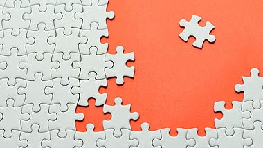 jigsaw puzzle pieces used as HR resources with orange background